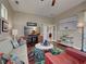 Bright living room features hardwood floors, colorful rug, and sliding doors to other rooms at 515 Sawgrass Bridge Rd, Venice, FL 34292