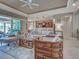 Open-concept living room with views of the modern kitchen and outdoor patio through sliding glass doors at 515 Sawgrass Bridge Rd, Venice, FL 34292