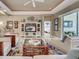 Bright living room with entertainment center, stylish decor, and sliding glass doors to a patio at 515 Sawgrass Bridge Rd, Venice, FL 34292