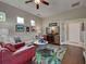 Cozy living room with hardwood floors, bright colorful rug, and easy access to other areas at 515 Sawgrass Bridge Rd, Venice, FL 34292