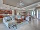 Spacious open-concept living area with modern furnishings, a ceiling fan, and access to dining and kitchen at 515 Sawgrass Bridge Rd, Venice, FL 34292