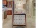 A stylish living area featuring an ornate table, wood cabinets, and a tiled floor in a neutral color palette at 515 Sawgrass Bridge Rd, Venice, FL 34292