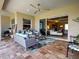 Inviting covered patio area, ideal for relaxing with comfortable seating and outdoor decor at 515 Sawgrass Bridge Rd, Venice, FL 34292