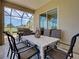 Covered outdoor dining area with a view of the green scenery; great spot for grilling at 515 Sawgrass Bridge Rd, Venice, FL 34292