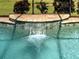 Inviting swimming pool with a water feature and stylish tile accents, perfect for relaxation at 515 Sawgrass Bridge Rd, Venice, FL 34292