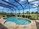 Screened-in pool area with a waterfall feature and beautiful golf course views at 515 Sawgrass Bridge Rd, Venice, FL 34292