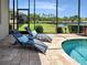 Relaxing pool area with sun loungers, scenic views, and a tranquil waterfront backdrop at 515 Sawgrass Bridge Rd, Venice, FL 34292