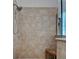 Modern shower with natural tile and a bench at 515 Sawgrass Bridge Rd, Venice, FL 34292