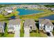 Aerial view of a home in a lakeside community, showcasing the surrounding houses and picturesque water feature at 5222 Granite Dust Pl, Palmetto, FL 34221