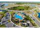 Community pool with palm trees, a roundabout, and walking trails around the pond and wooded area at 5222 Granite Dust Pl, Palmetto, FL 34221