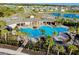 Community pool with palm trees, a roundabout, and walking trails around the pond and wooded area at 5222 Granite Dust Pl, Palmetto, FL 34221