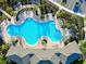 Community pool with lounge chairs and landscaping viewed from above on a sunny day at 5222 Granite Dust Pl, Palmetto, FL 34221