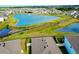 An aerial view showcases a pond surrounded by houses, with neat landscaping and community layout at 5222 Granite Dust Pl, Palmetto, FL 34221