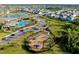 Community pool with palm trees, playground, roundabout, pond, and wooded areas in the neighborhood at 5222 Granite Dust Pl, Palmetto, FL 34221