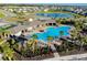 Community pool with palm trees, a roundabout, and walking trails around the pond and wooded area at 5222 Granite Dust Pl, Palmetto, FL 34221