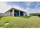 Spacious backyard featuring a well-maintained lawn and screened patio with a partial view of the home's exterior at 5222 Granite Dust Pl, Palmetto, FL 34221