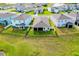 Aerial view of a home's backyard featuring a screened lanai and black metal fence around the perimeter at 5222 Granite Dust Pl, Palmetto, FL 34221