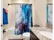 Well-lit bathroom with a granite countertop, shower/tub and stylish curtain at 5222 Granite Dust Pl, Palmetto, FL 34221