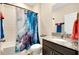 Well-lit bathroom with a granite countertop, shower/tub and stylish curtain at 5222 Granite Dust Pl, Palmetto, FL 34221