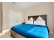 Comfortable bedroom featuring a wood bed frame and a striking blue comforter at 5222 Granite Dust Pl, Palmetto, FL 34221