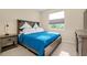 Comfortable bedroom with a wooden bed frame, bright blue comforter, and a side table at 5222 Granite Dust Pl, Palmetto, FL 34221