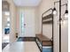 Bright foyer featuring tile floors, a decorative rug, and a coat rack with bench seating at 5222 Granite Dust Pl, Palmetto, FL 34221