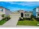 Charming home with a two-car garage, manicured lawn, and a stone-accented facade, creating appealing curb appeal at 5222 Granite Dust Pl, Palmetto, FL 34221
