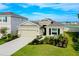 Charming single-Gathering home with a manicured lawn, two-car garage, complemented by blue skies and neighborhood views at 5222 Granite Dust Pl, Palmetto, FL 34221