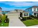 Beautiful single-Gathering home featuring a well-manicured lawn, stone accents, and a two-car garage at 5222 Granite Dust Pl, Palmetto, FL 34221