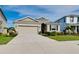 Well-maintained one-story home featuring a two-car garage, lush lawn, and manicured landscape in daytime at 5222 Granite Dust Pl, Palmetto, FL 34221