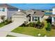 Attractive one-story home with a two-car garage, stone veneer, and manicured landscaping near a lake at 5222 Granite Dust Pl, Palmetto, FL 34221