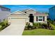 Charming single-Gathering home with a two-car garage, stone accents, and beautifully landscaped front yard at 5222 Granite Dust Pl, Palmetto, FL 34221