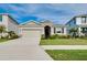Charming one-story home with a two-car garage, landscaped front yard, and well-maintained lawn on a sunny day at 5222 Granite Dust Pl, Palmetto, FL 34221