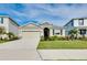 Inviting one-story home with a two-car garage, lush lawn, and manicured landscape on a sunny day at 5222 Granite Dust Pl, Palmetto, FL 34221