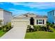 Well-maintained single-story home featuring a manicured lawn, stone accents, and a two-car garage at 5222 Granite Dust Pl, Palmetto, FL 34221
