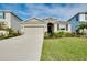Charming single-story home with a well-manicured lawn, lush landscaping, and a two-car garage at 5222 Granite Dust Pl, Palmetto, FL 34221
