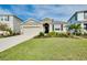 Charming single-story home with a well-manicured lawn, lush landscaping, and a two-car garage at 5222 Granite Dust Pl, Palmetto, FL 34221