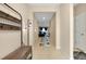 Inviting hallway with tile floors, coat rack, and seamless access to the living areas at 5222 Granite Dust Pl, Palmetto, FL 34221