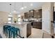 Stylish kitchen with granite countertops, dark cabinets, stainless steel appliances, and a breakfast bar at 5222 Granite Dust Pl, Palmetto, FL 34221