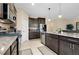 Modern kitchen features stainless steel appliances, granite countertops, and dark wood cabinetry at 5222 Granite Dust Pl, Palmetto, FL 34221