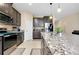 Open kitchen boasts granite counters, stainless appliances, and large island with pendant lighting at 5222 Granite Dust Pl, Palmetto, FL 34221