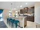 Modern kitchen featuring a large island with seating, granite countertops, and stainless steel appliances at 5222 Granite Dust Pl, Palmetto, FL 34221