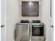 Functional laundry room with modern washer and dryer and cabinet space at 5222 Granite Dust Pl, Palmetto, FL 34221