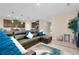 Open living space showcasing a leather sectional, view of the kitchen, and stylish decor at 5222 Granite Dust Pl, Palmetto, FL 34221