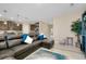 Living room with leather sectional sofa offering view into kitchen and eating nook at 5222 Granite Dust Pl, Palmetto, FL 34221