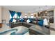 Comfortable living room featuring an oversized sectional sofa, blue accents, and open-concept design at 5222 Granite Dust Pl, Palmetto, FL 34221
