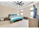 Spacious main bedroom with tray ceiling, neutral carpet, and large TV at 5222 Granite Dust Pl, Palmetto, FL 34221