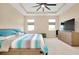 Comfortable main bedroom with tray ceiling, neutral decor, and ample natural light at 5222 Granite Dust Pl, Palmetto, FL 34221