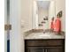 Cozy powder room with granite counters, wood cabinet, and nautical-themed decorations at 5222 Granite Dust Pl, Palmetto, FL 34221