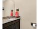 Comfortable powder room with granite counters, wood cabinet, and decorative nautical themed accents at 5222 Granite Dust Pl, Palmetto, FL 34221